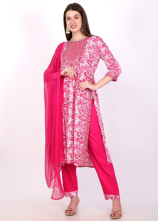 Full view of a woman dressed in a pink kurta set with white threadwork embroidery and a sheer dupatta.