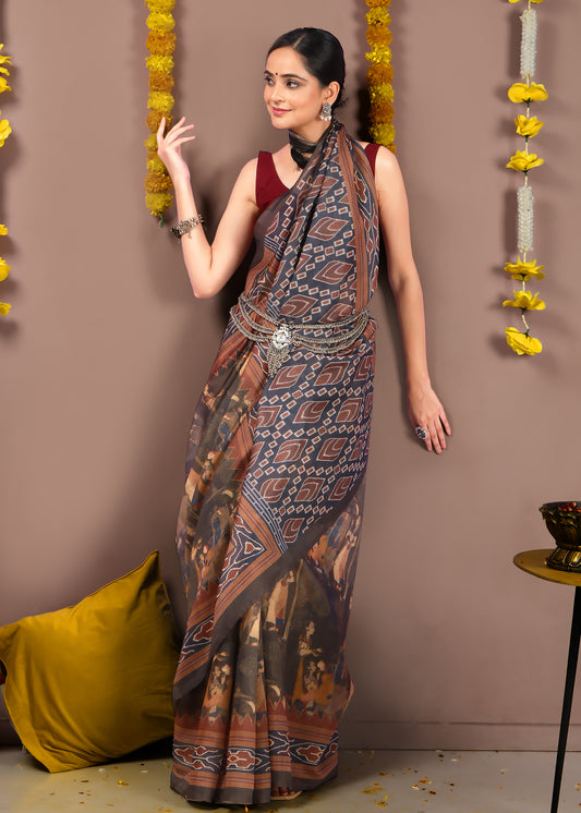 Elegant close-up of a woman showcasing the intricate Ikat weave of her brown saree paired with silver jewelry