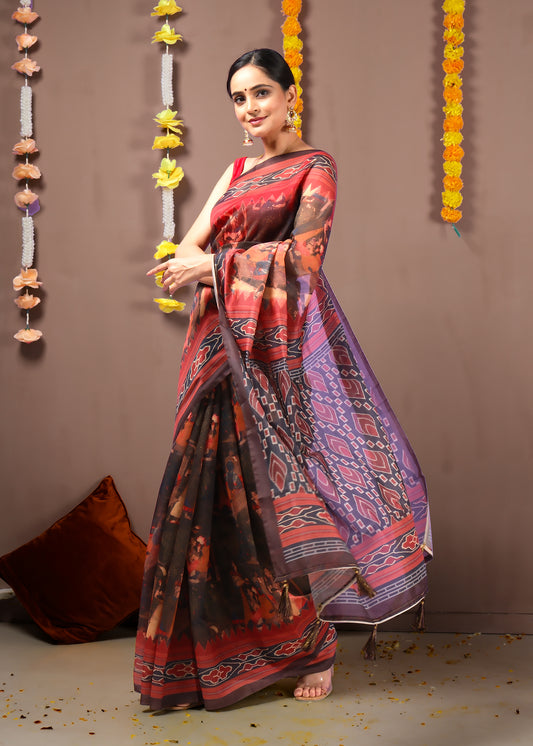 Side profile of a woman showcasing the detailed pallu and bold borders of an Ikat saree.