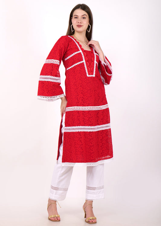 A front-facing look at the red lace kurta with white lace accents, styled with a simple necklace and white pants