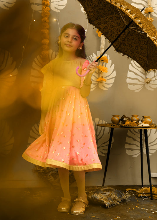 Girl holding a decorative umbrella, wearing a peach and gold traditional dress, perfect for Indian festivals or special occasions.