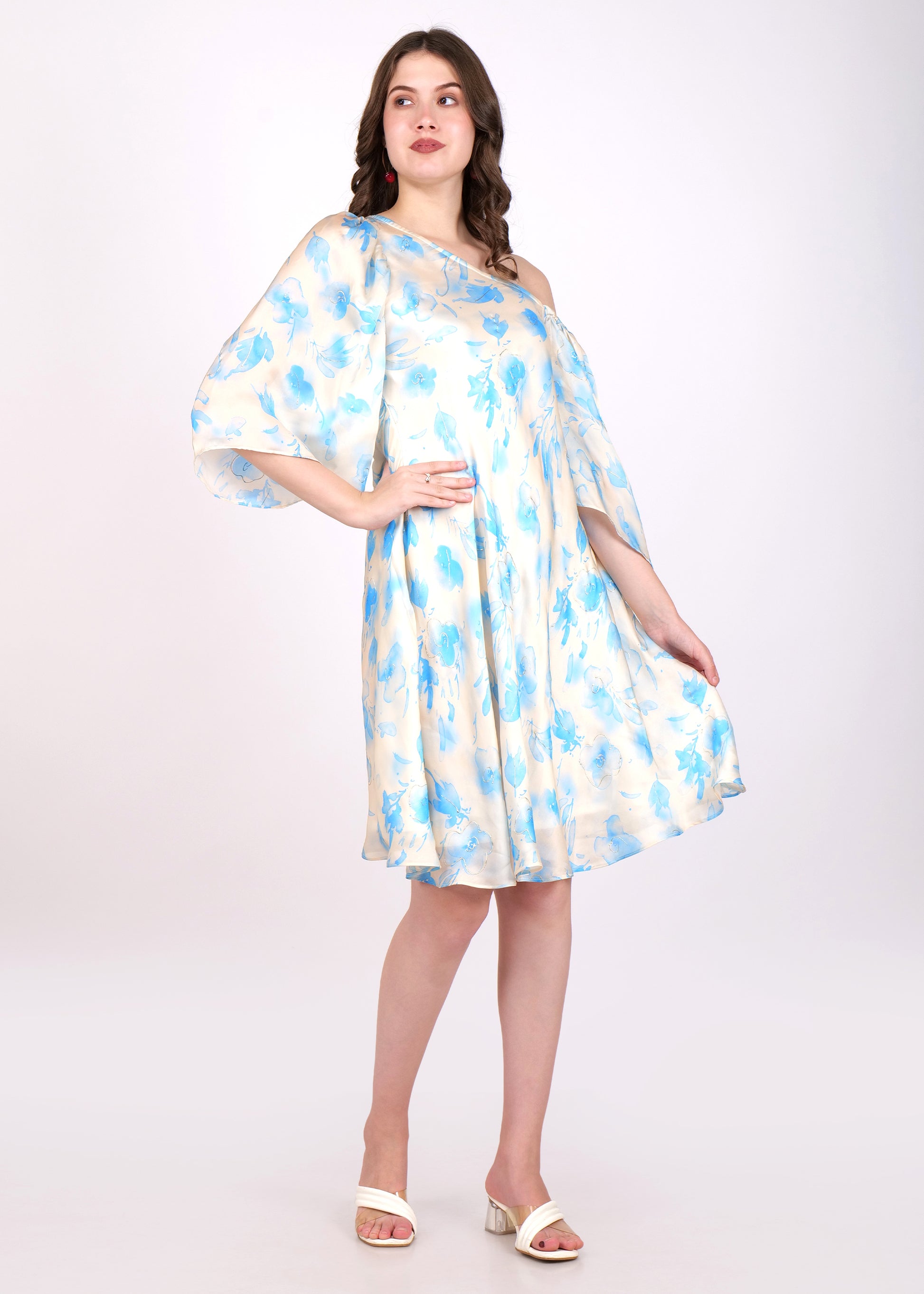 Stylish off-shoulder cream dress with blue flowers, modeled by a woman