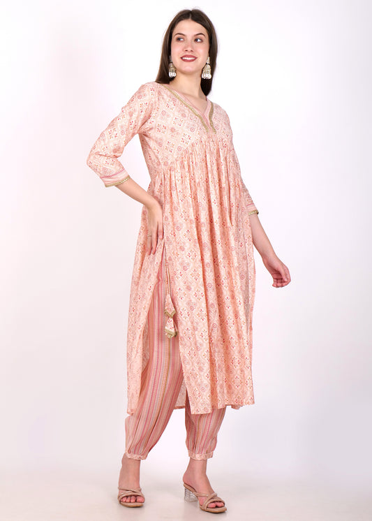 "Stylish peach ethnic suit set with an Anarkali kurta and matching striped salwar, a blend of elegance and comfort."