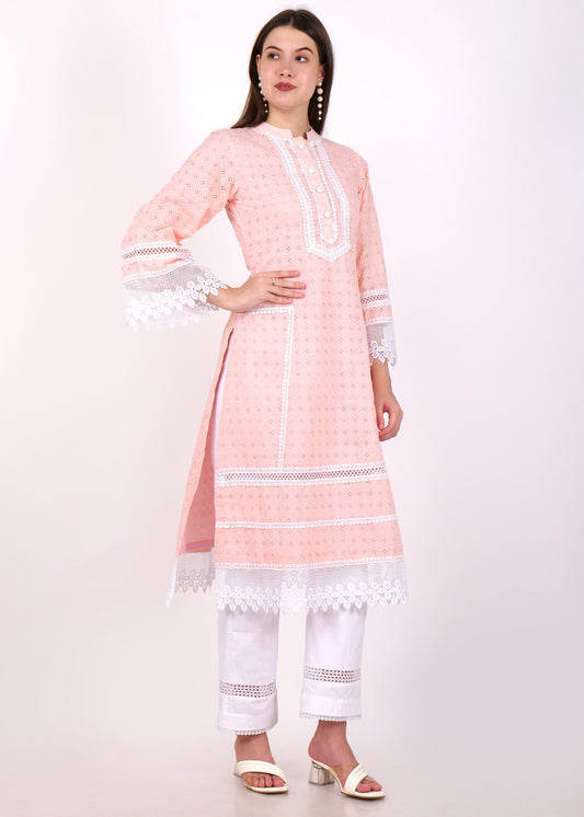 Full front view of a woman in a pastel pink ethnic kurta with intricate lace detailing and white cotton pants