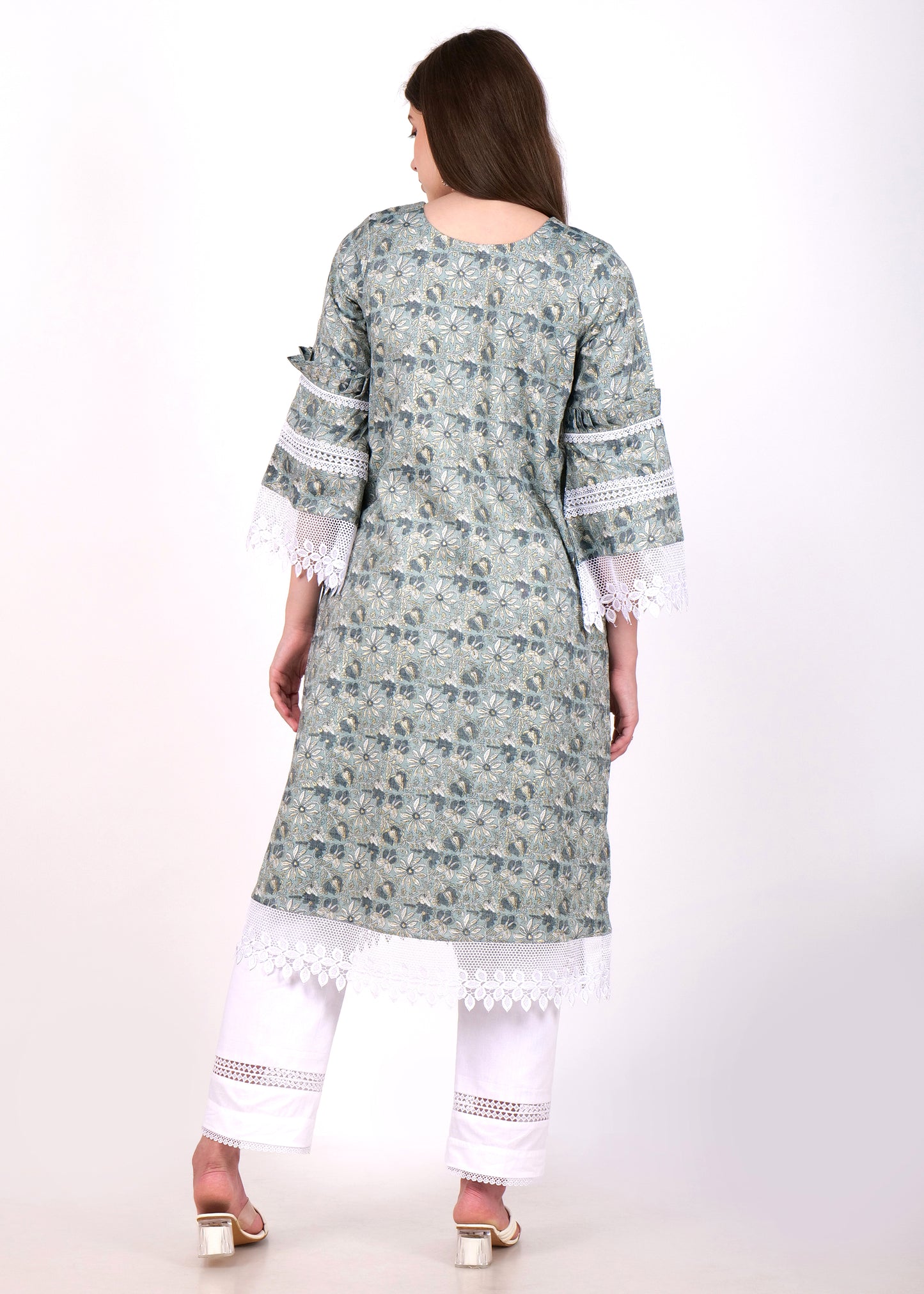 Rear view of a woman modeling a traditional green floral kurta with lace details and bell sleeves, paired with white pants