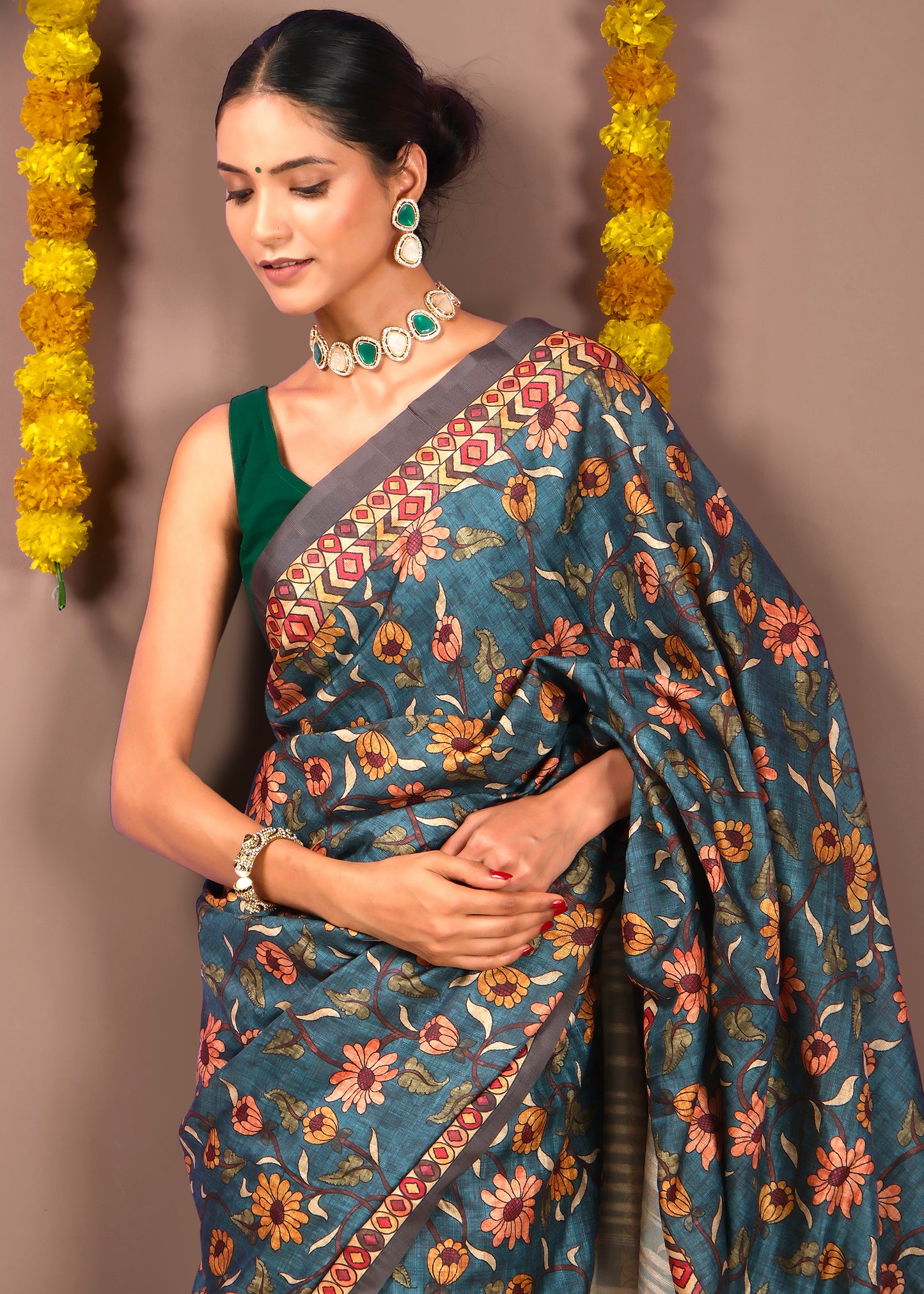 Close-up view of floral patterned saree with geometric border design