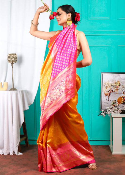 Woman in a festive orange silk saree with a pink pallu, holding roses, styled with colorful earrings and a playful pose