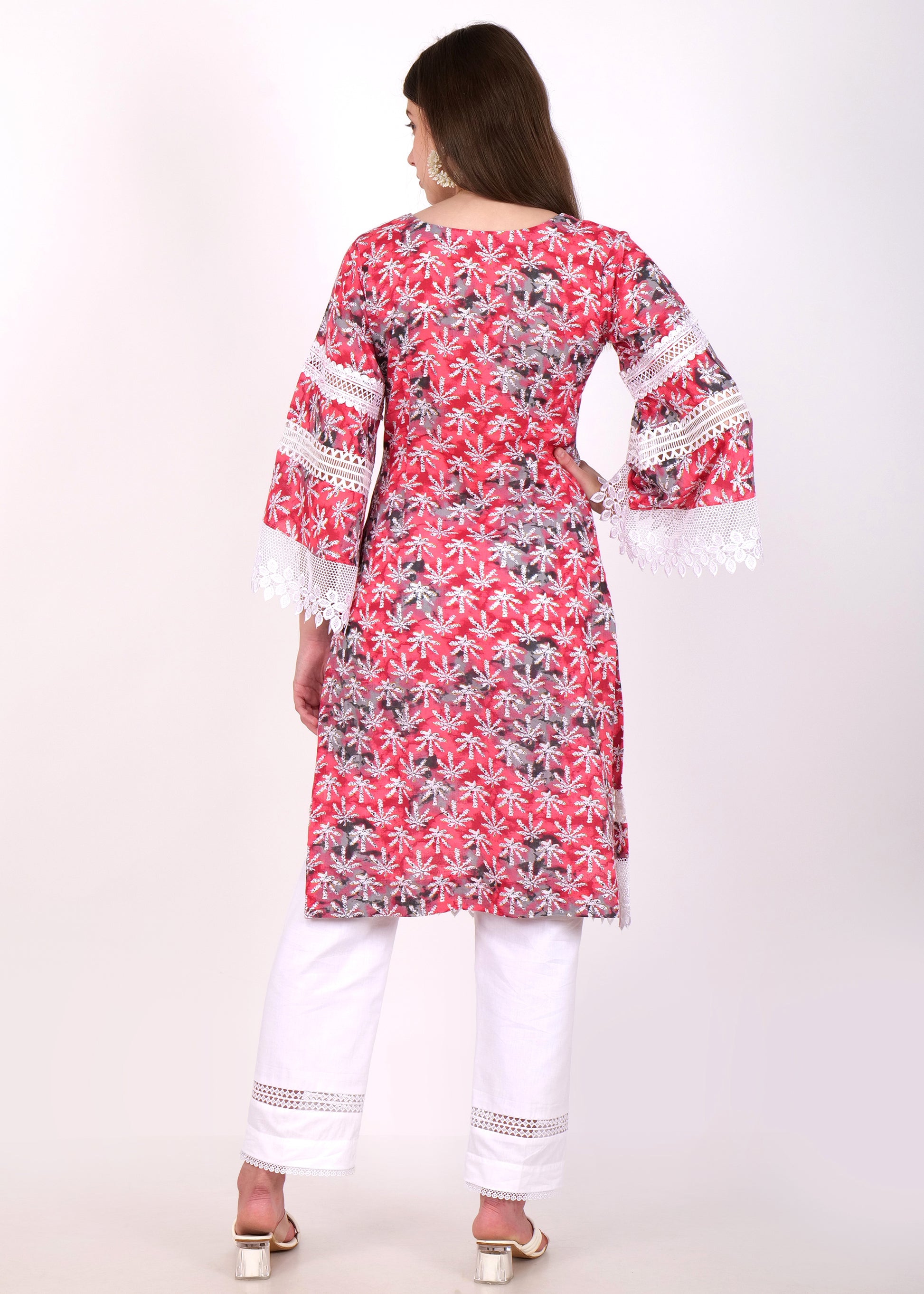 "Back view of red floral printed kurti with white lace accents, paired with white straight pants"