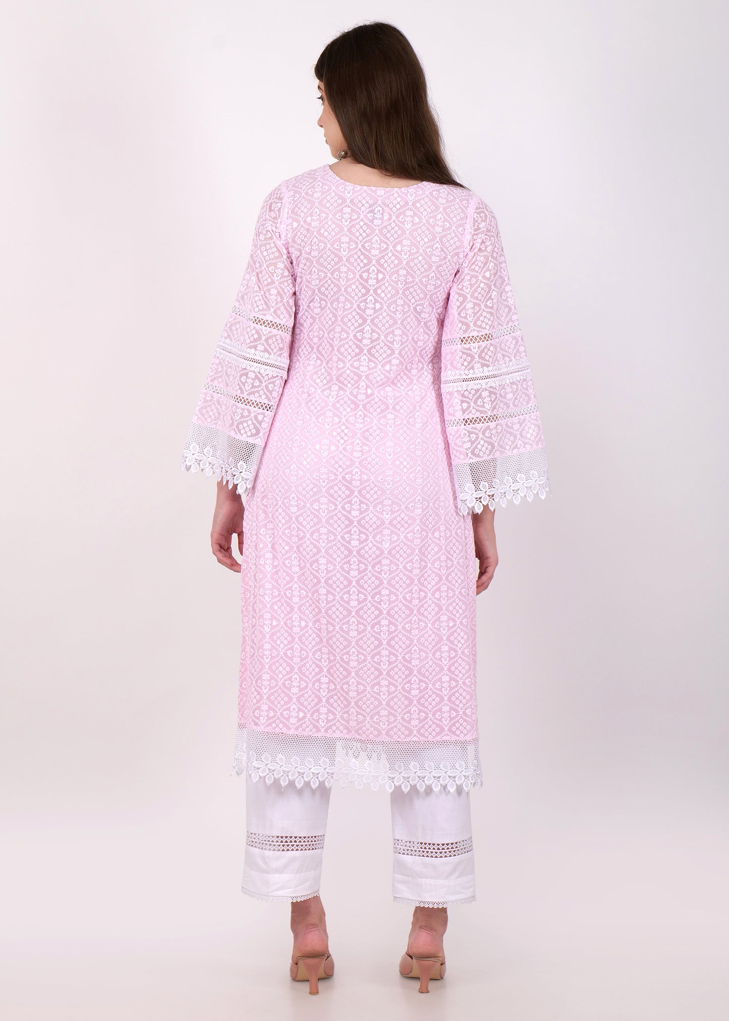 Back view of a pink lace kurta with detailed embroidery, styled with white pants