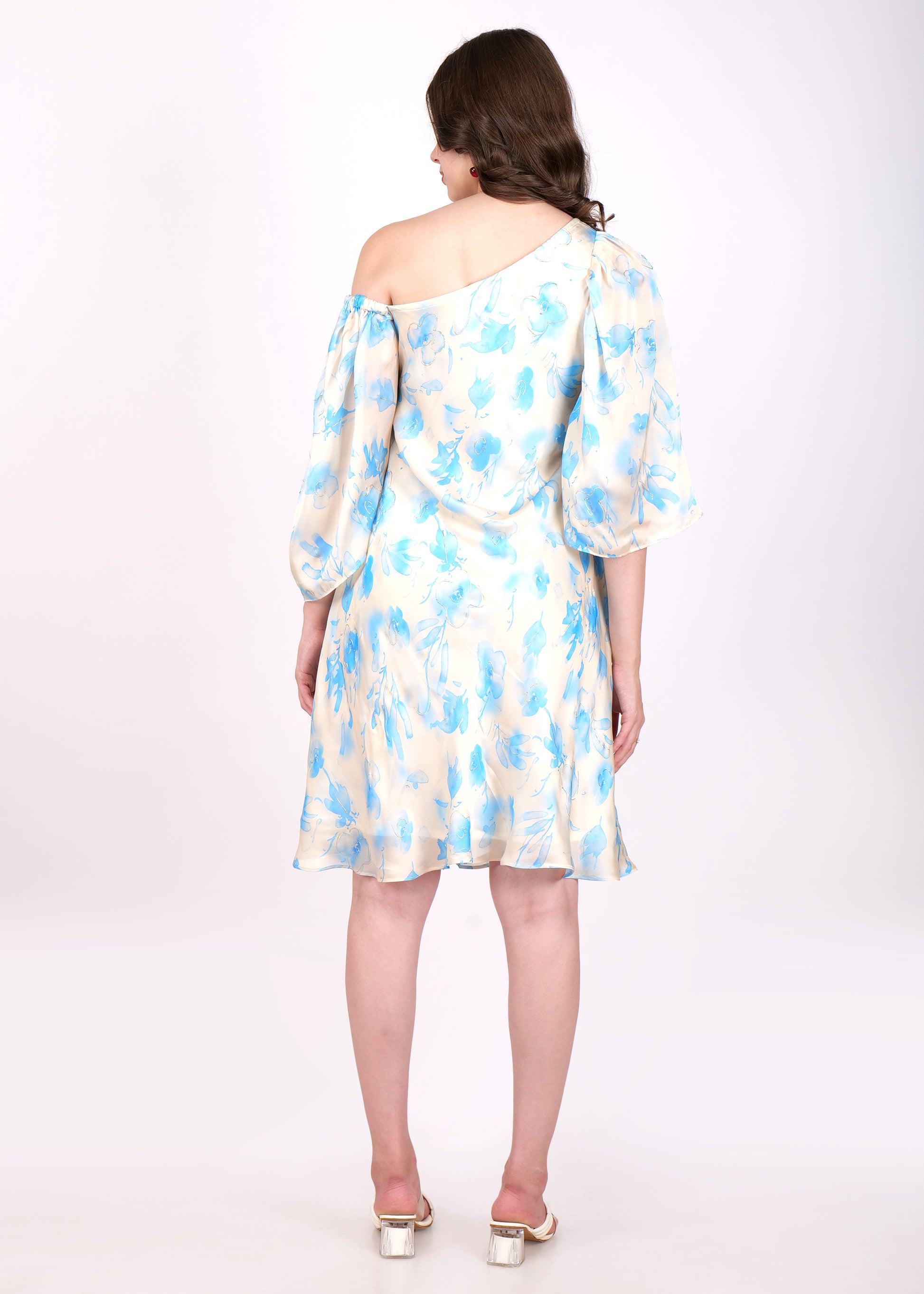 Back view of a cream-colored floral dress with blue flower designs