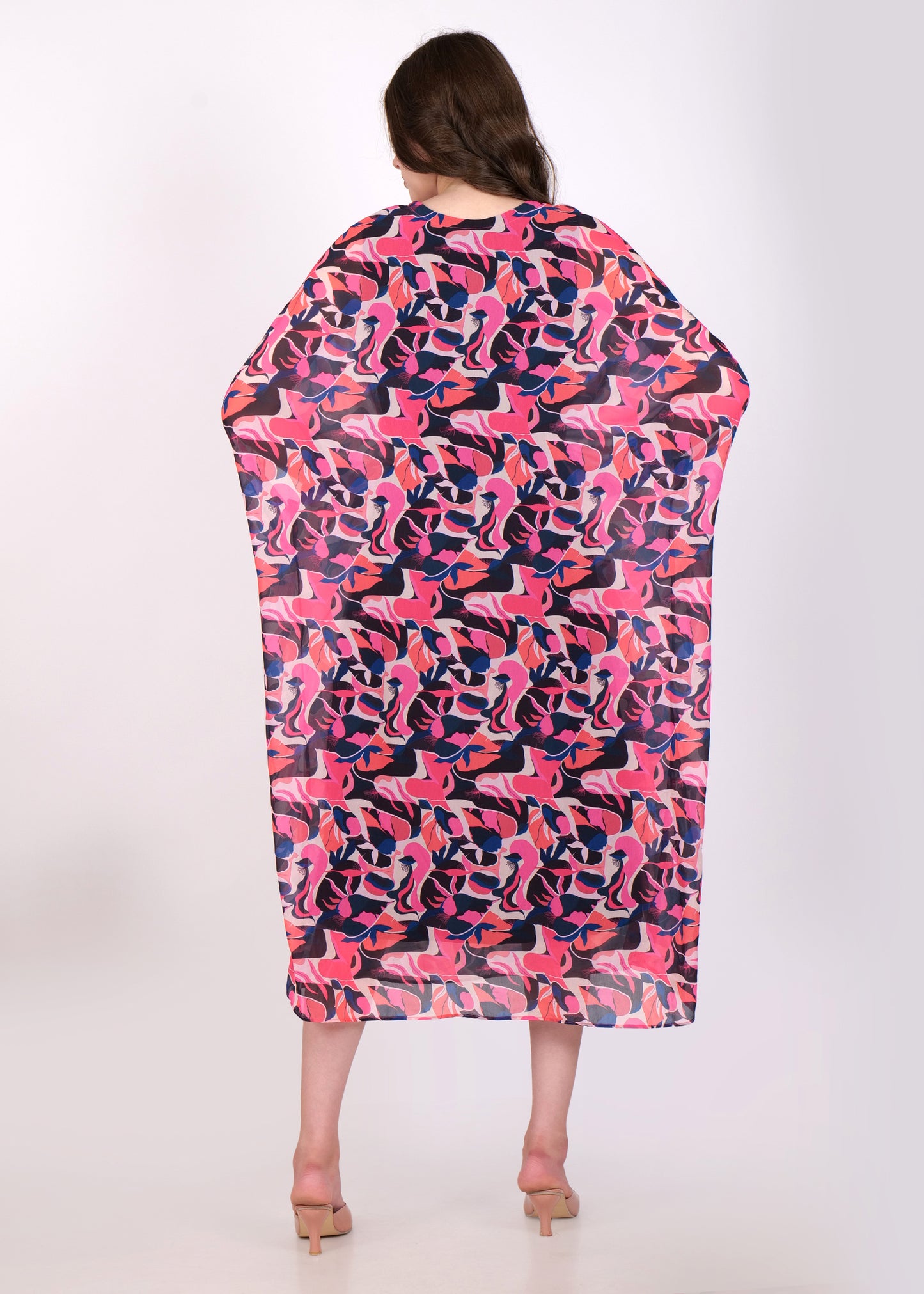  Back view of the pink and purple abstract printed kaftan dress, highlighting the oversized fit and bold pattern