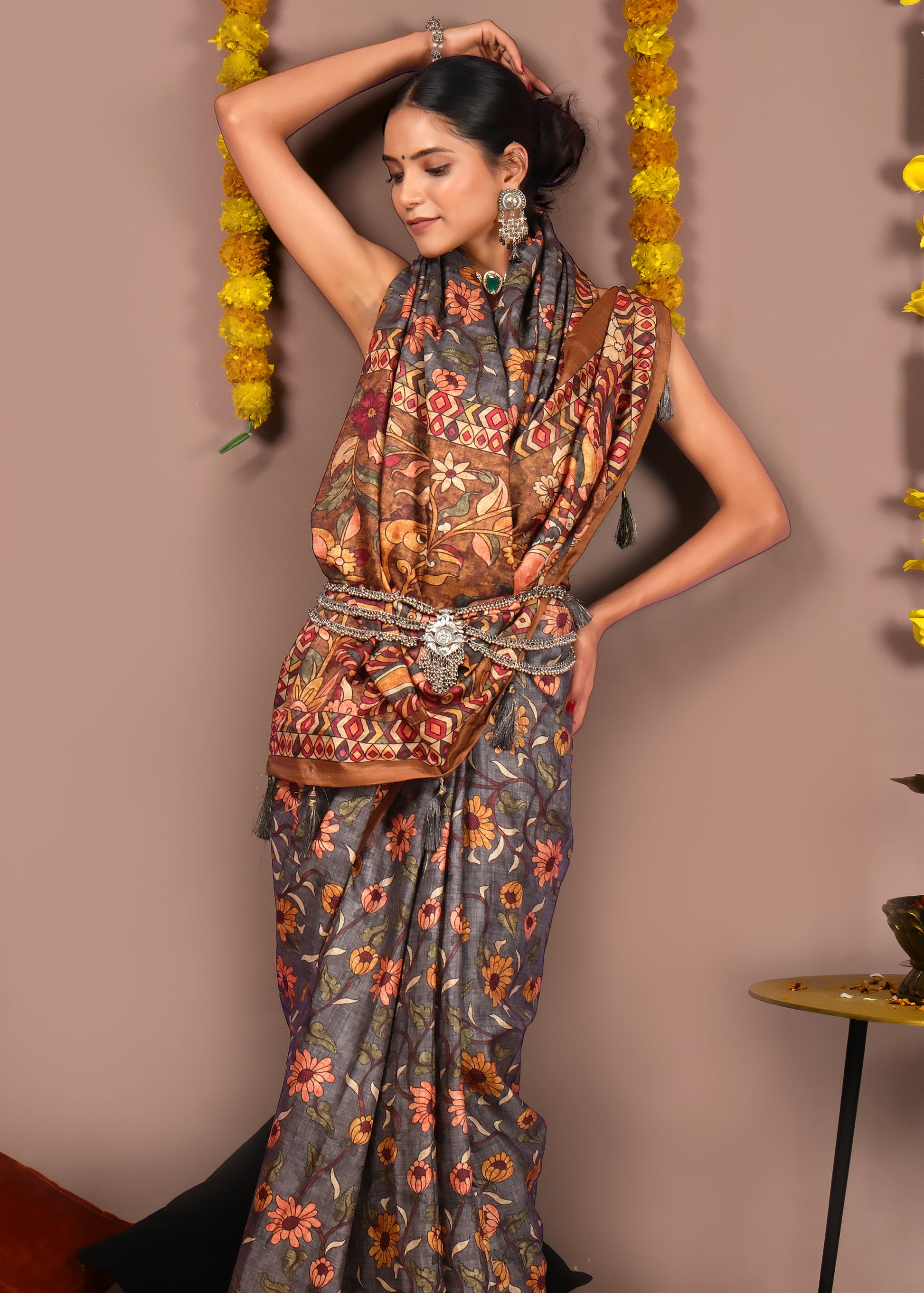 Stylish woman in a traditional floral printed saree with ethnic accessories