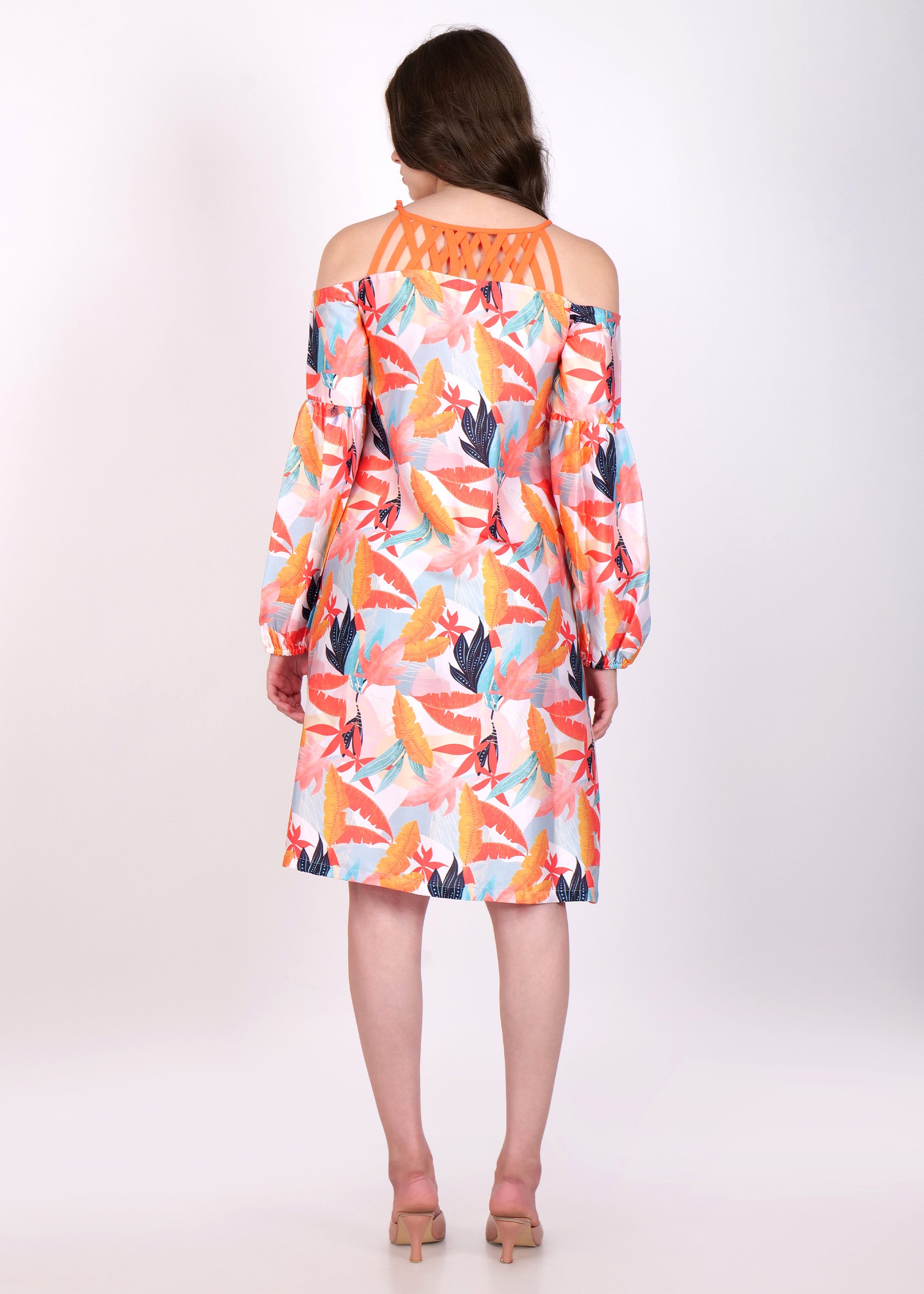Back view of tropical leaf print dress with criss-cross orange straps and off-shoulder design.