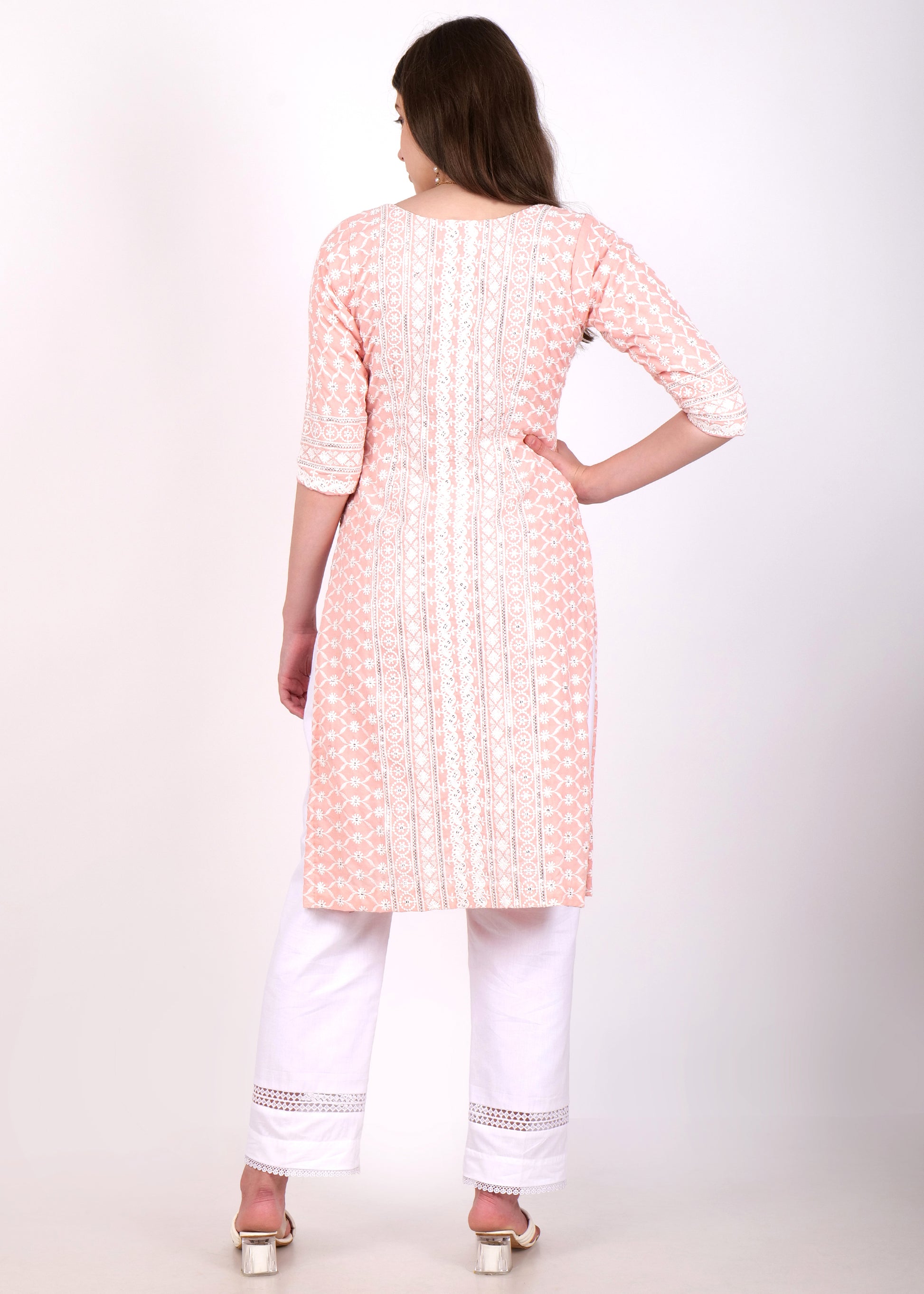 Back view of light pink embroidered cotton kurta with lacework, worn by model with white trousers