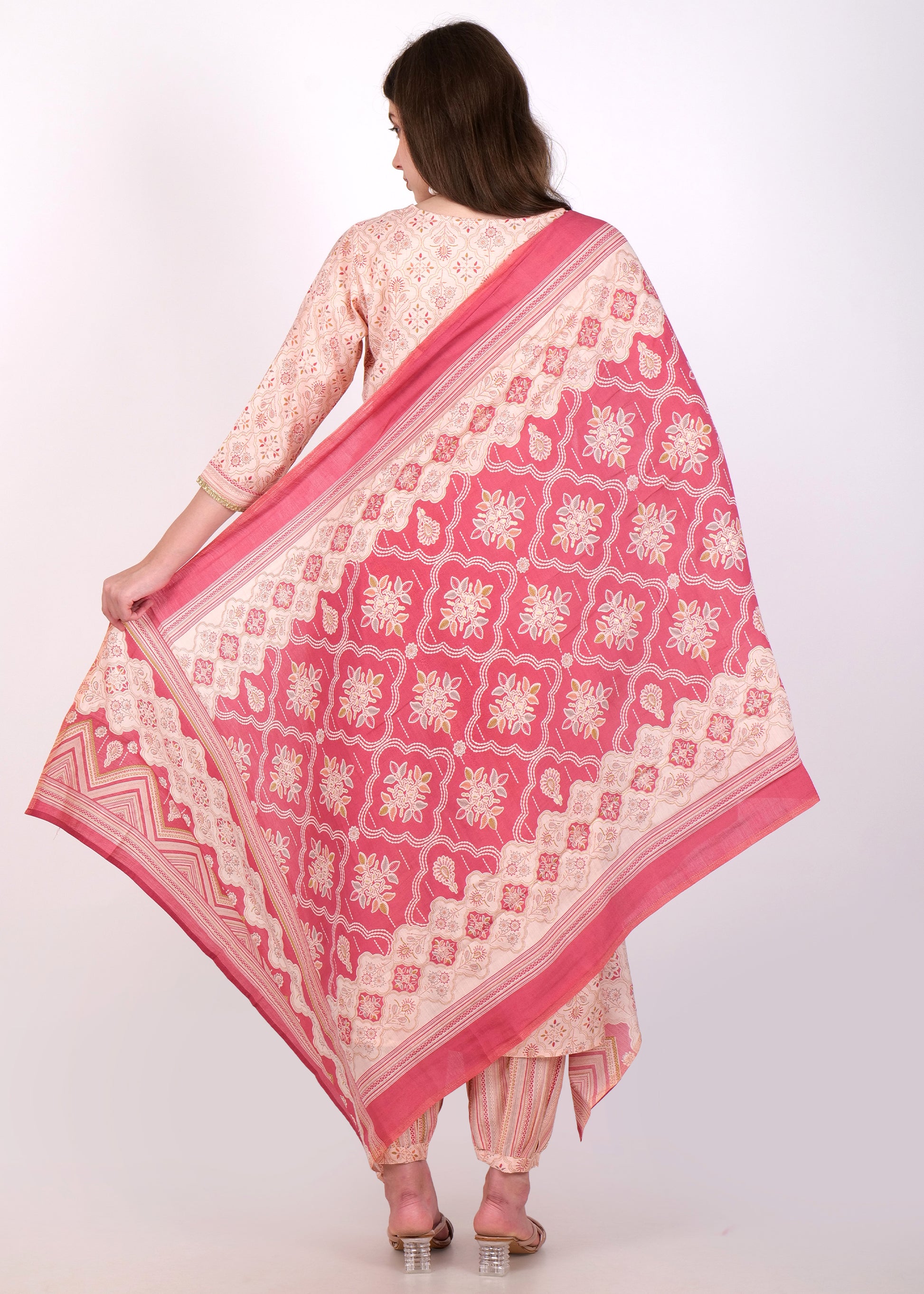 "Peach Anarkali suit with bold printed dupatta and striped pants, featuring a traditional yet modern design."