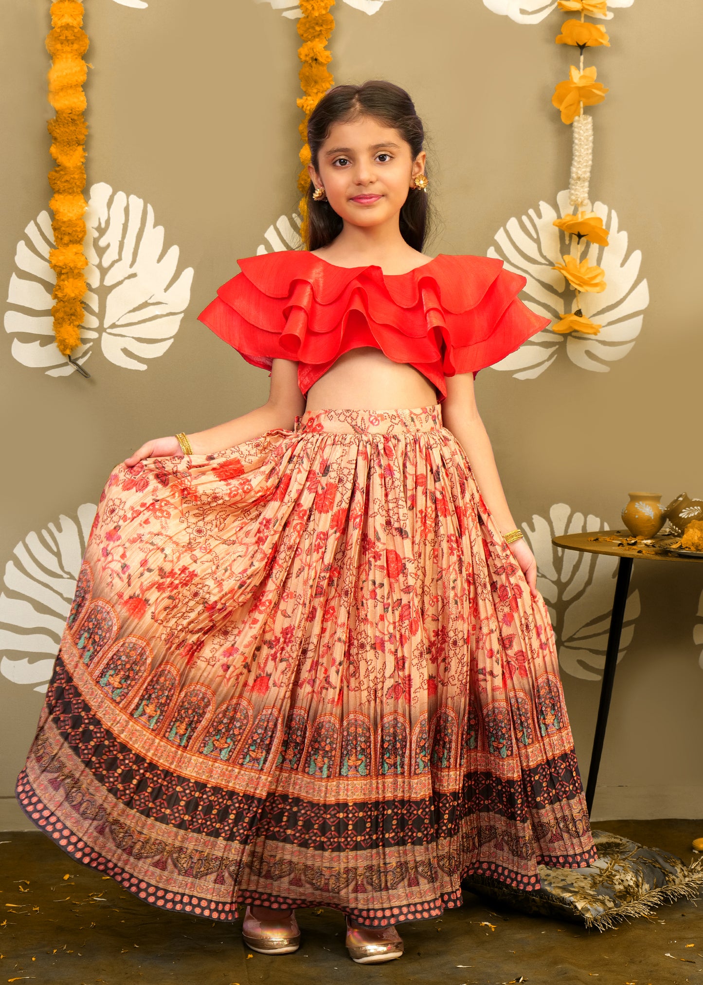 A twirling girl in a festive red crop top and intricately printed skirt, showcasing the fullness and beauty of the skirt design.