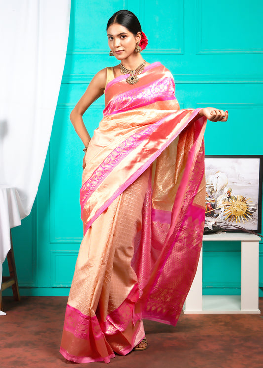 Detailed shot of the peach silk saree's border, highlighting the intricate design and craftsmanship