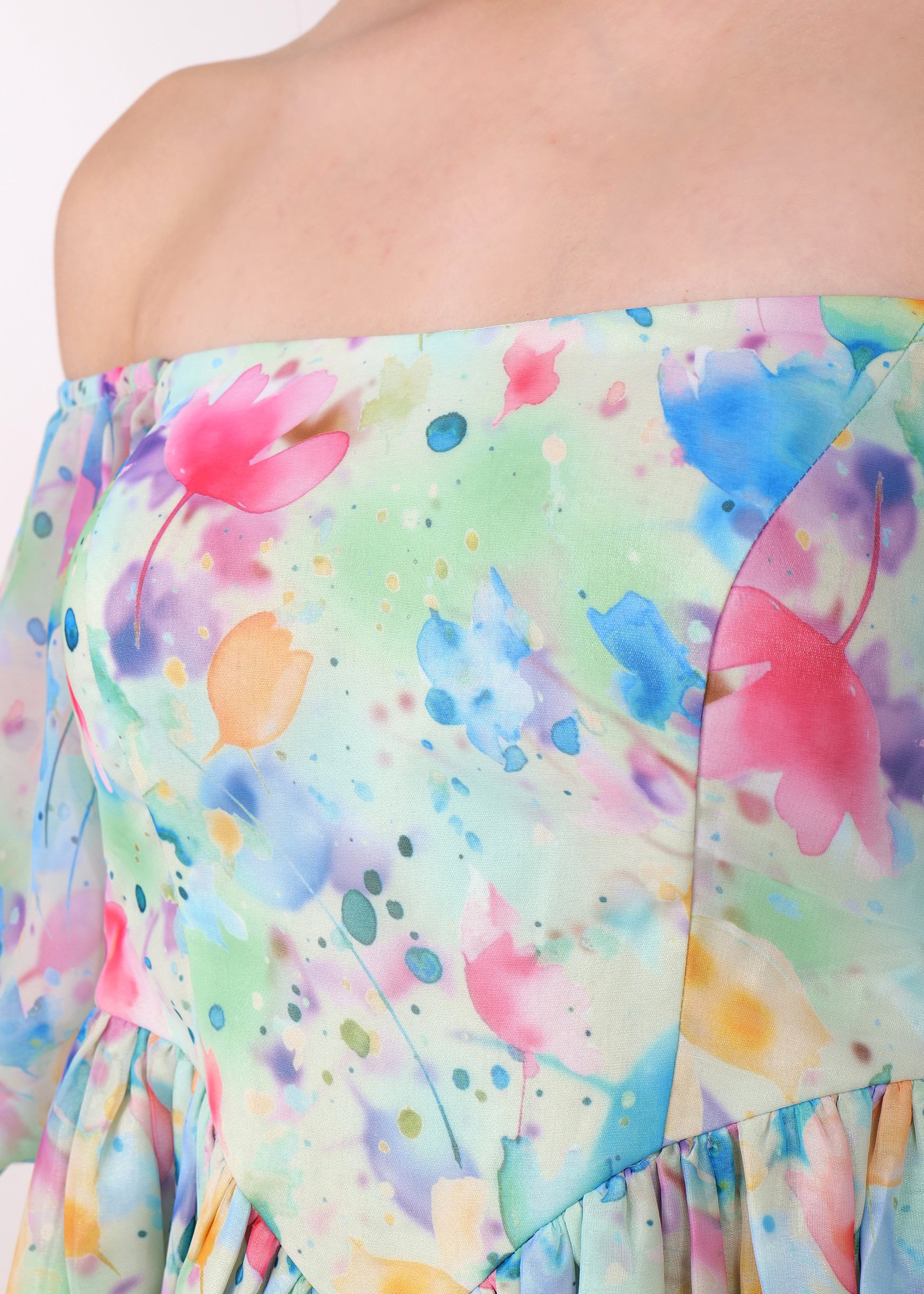 Close-up of the watercolor floral pattern on an off-shoulder dress