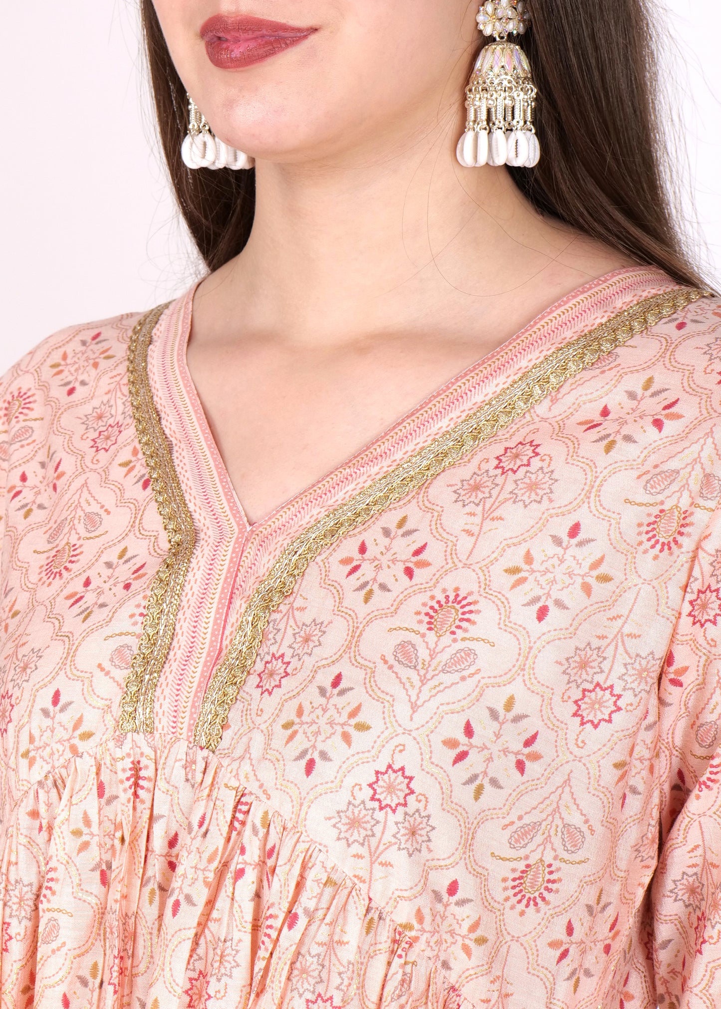 "Close-up of peach Anarkali kurta with golden detailing, highlighting its intricate embroidered neckline."