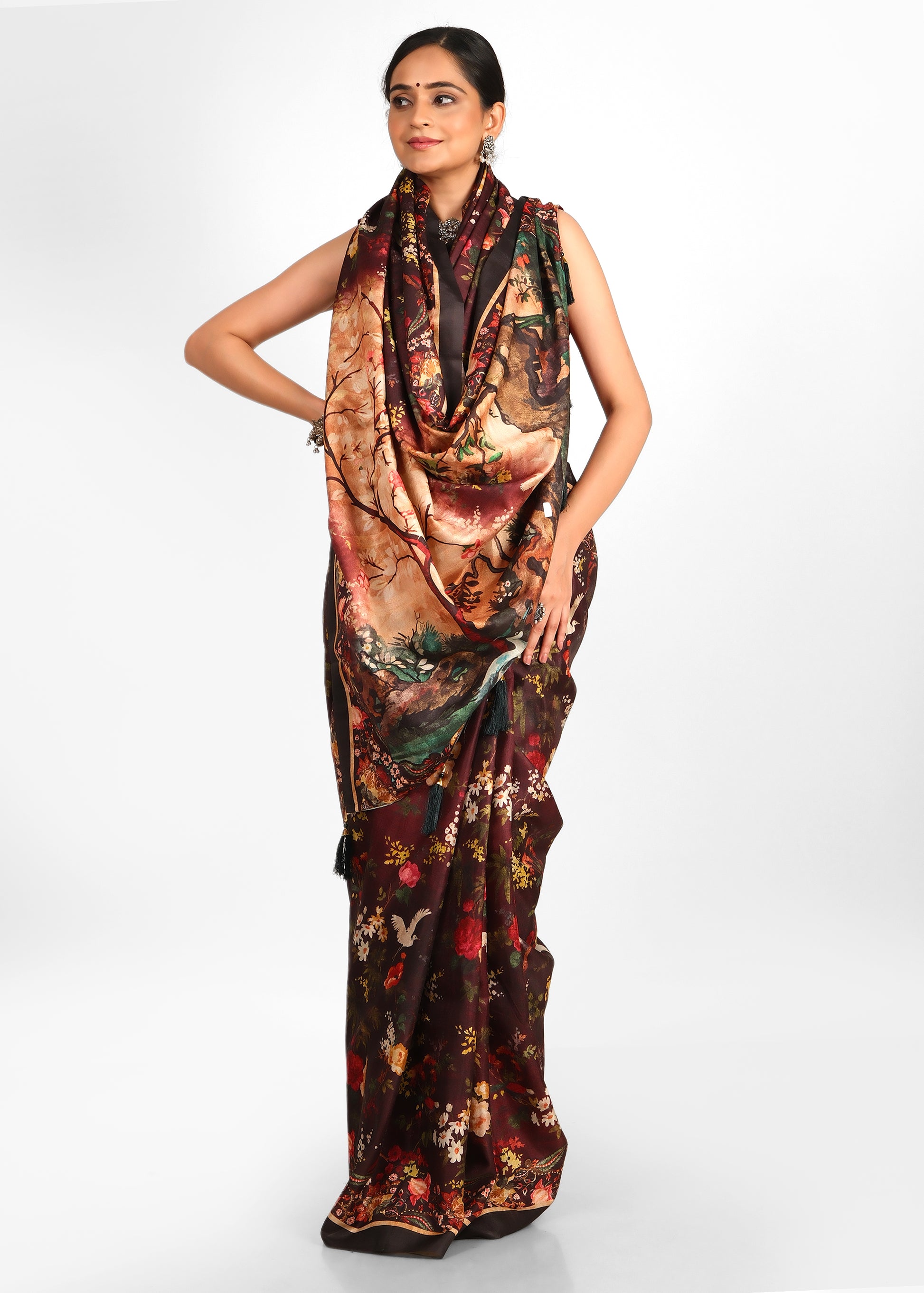 Front-facing view of a model in a maroon saree adorned with nature-inspired designs, showcasing exquisite craftsmanship