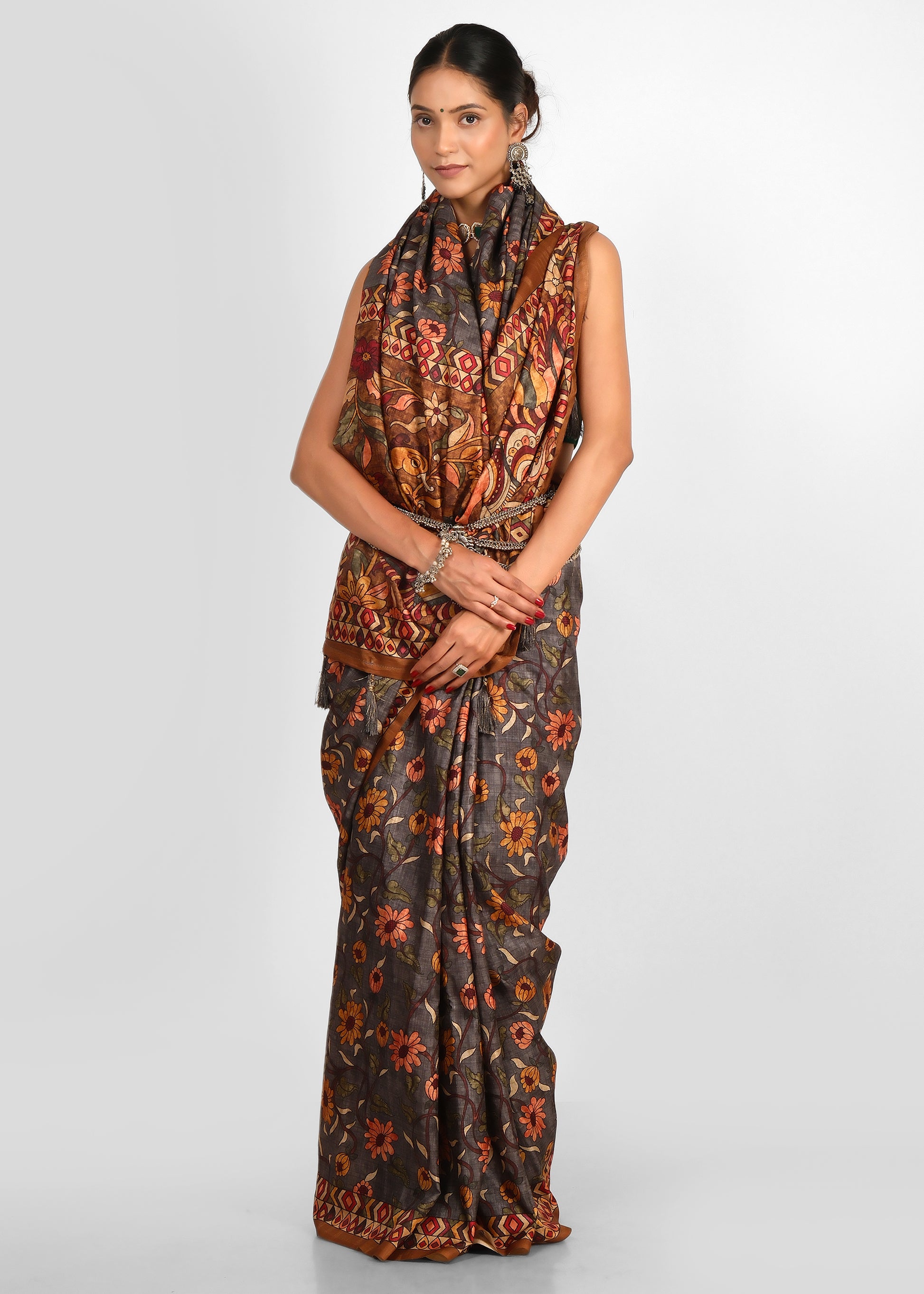 Stylish woman in a traditional floral printed saree with ethnic accessories