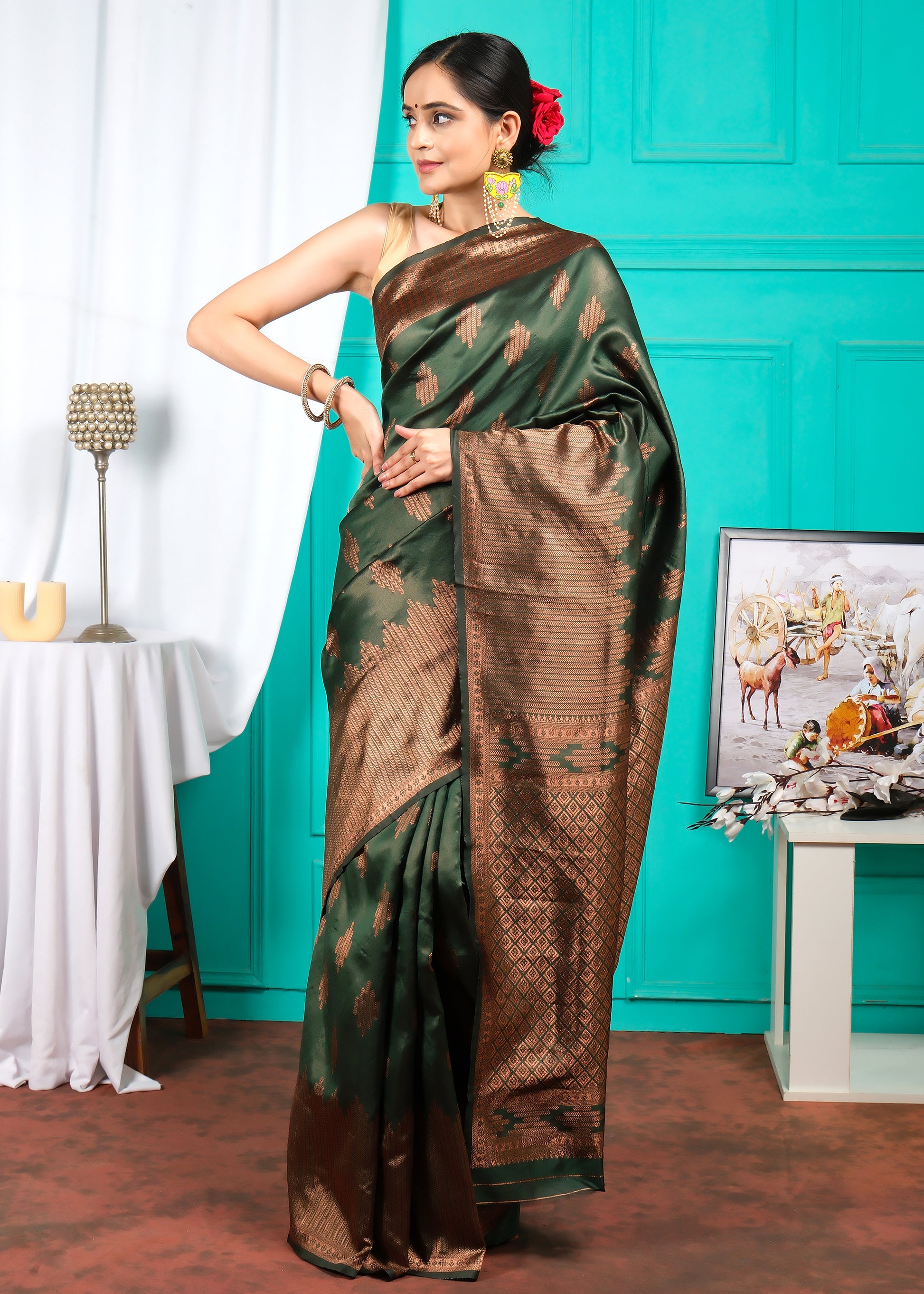 Full-length shot of a woman wearing a green and brown silk saree, styled elegantly for a formal occasion.