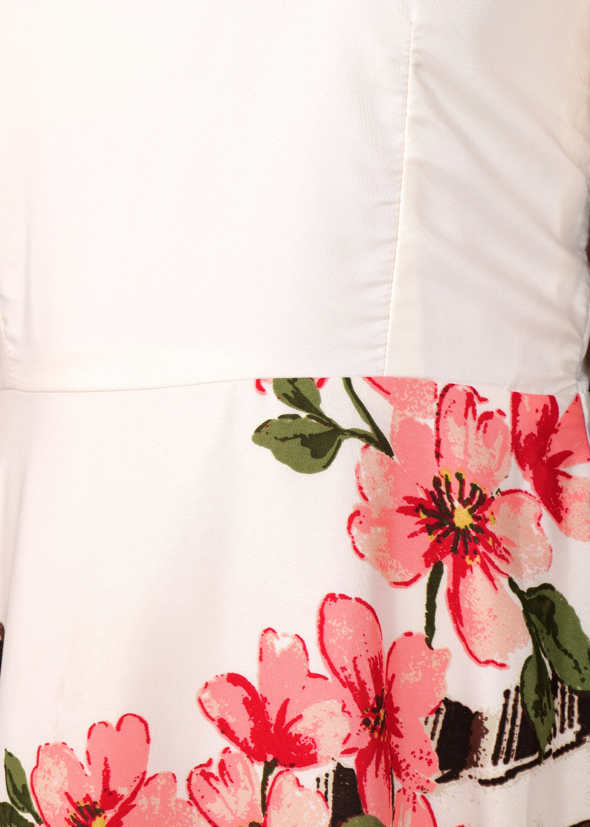 Close-up of a beige satin floral dress, showcasing intricate pink flower detailing on the A-line skirt, highlighting the bold print on a smooth fabric