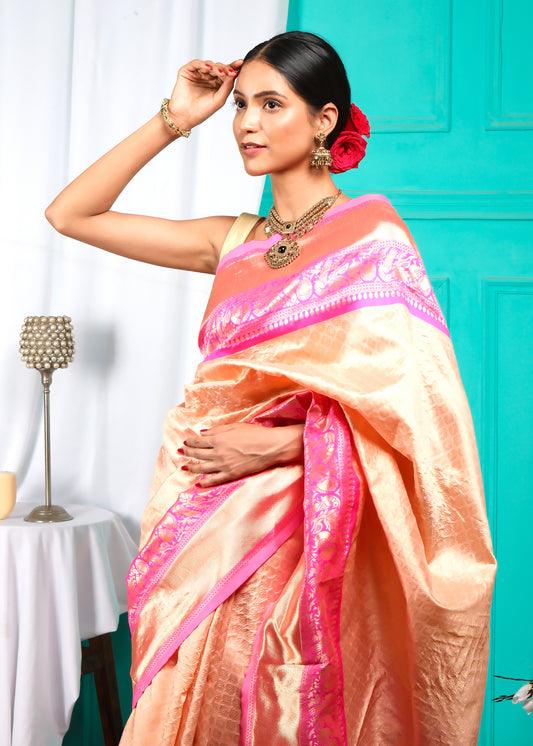 Detailed shot of the peach silk saree's border, highlighting the intricate design and craftsmanship