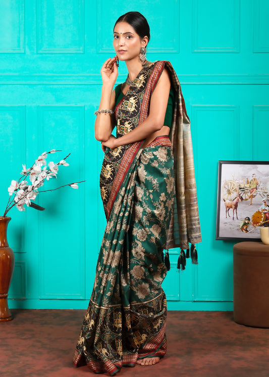 Side view of a woman in a classic green saree with intricate patterns, temple artwork, and gold detailing, perfect for festive or cultural occasions.