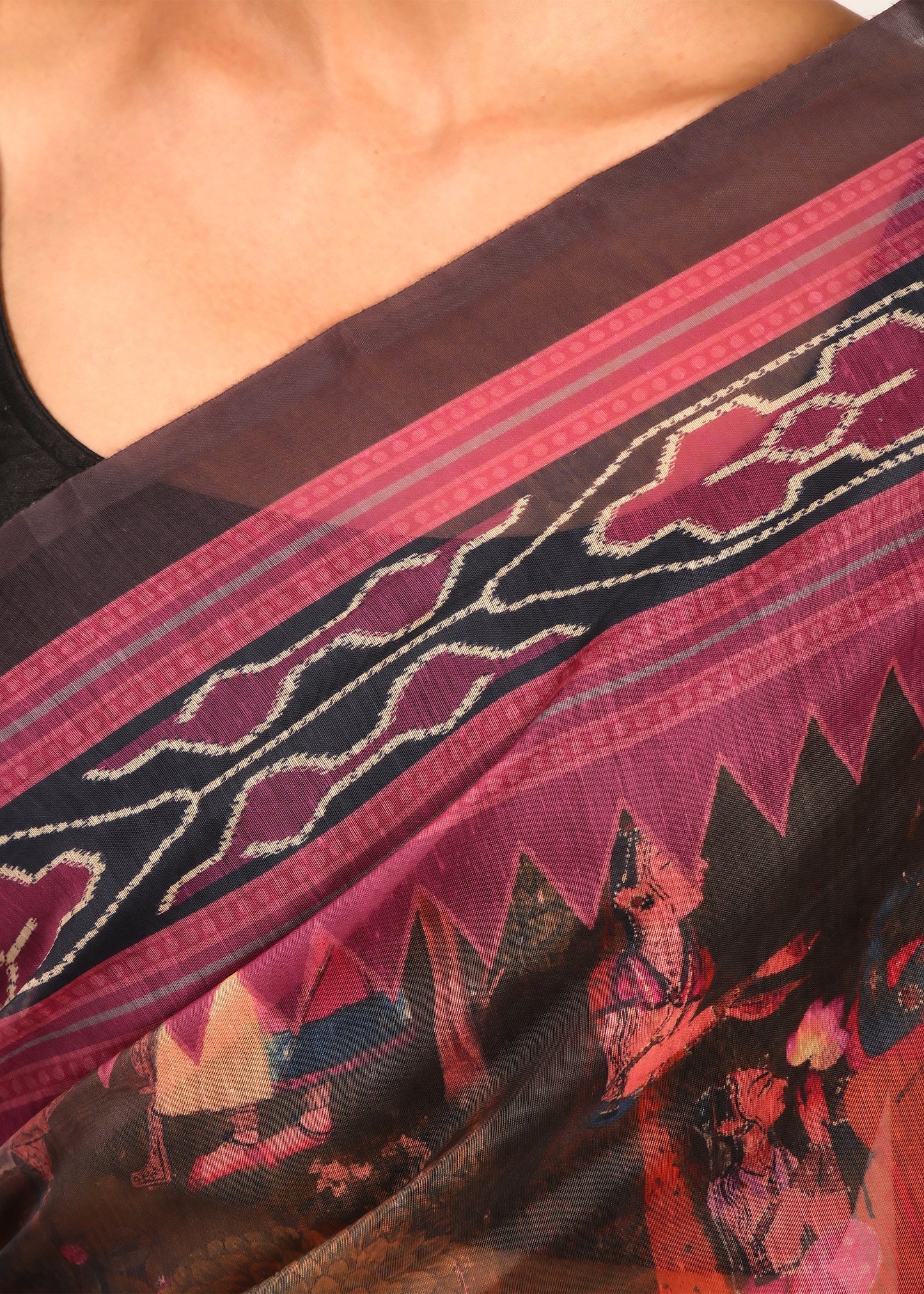 Zoomed-in view of a Krishna Rasleela print saree with vibrant purples and browns.