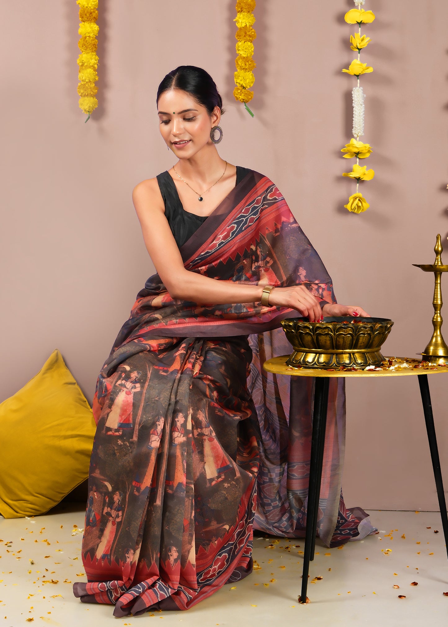 Model in a red and black saree with a blend of geometric and cultural motifs, exuding elegance for festive wear.