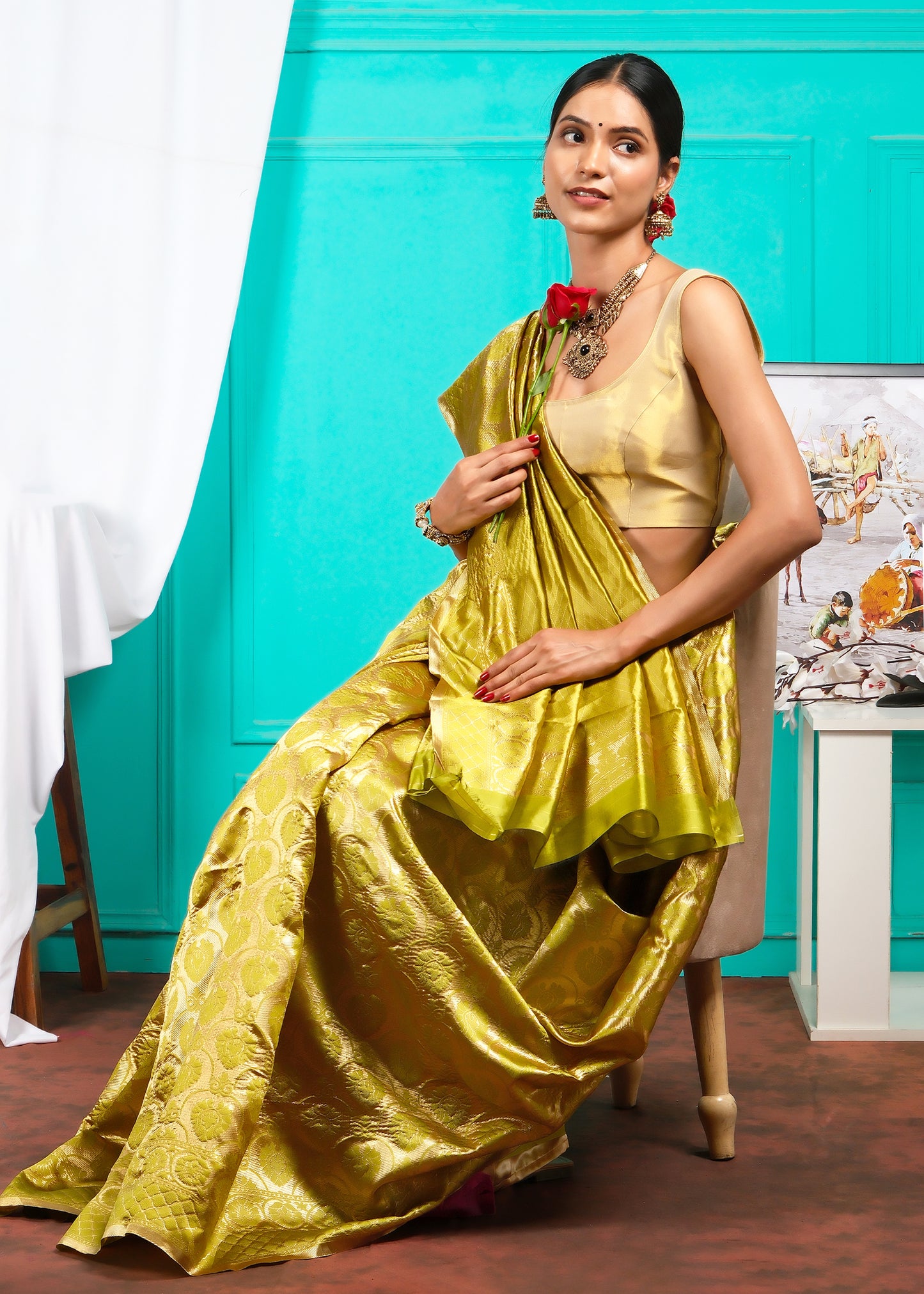 Woman draped in a traditional yellow Banarasi silk saree, holding red roses, exuding timeless elegance