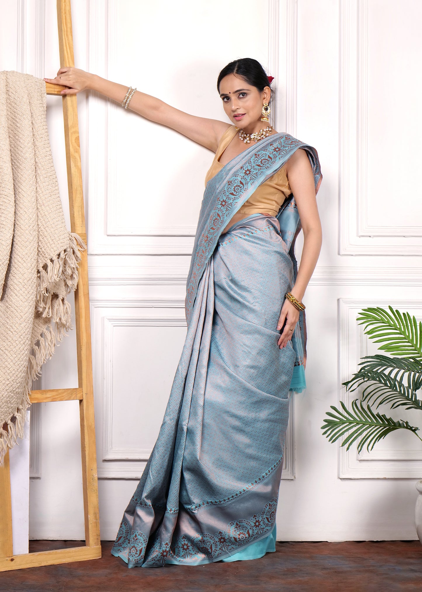 Full view of the light blue Banarasi silk saree draped gracefully, showcasing the intricate floral patterns and zari border