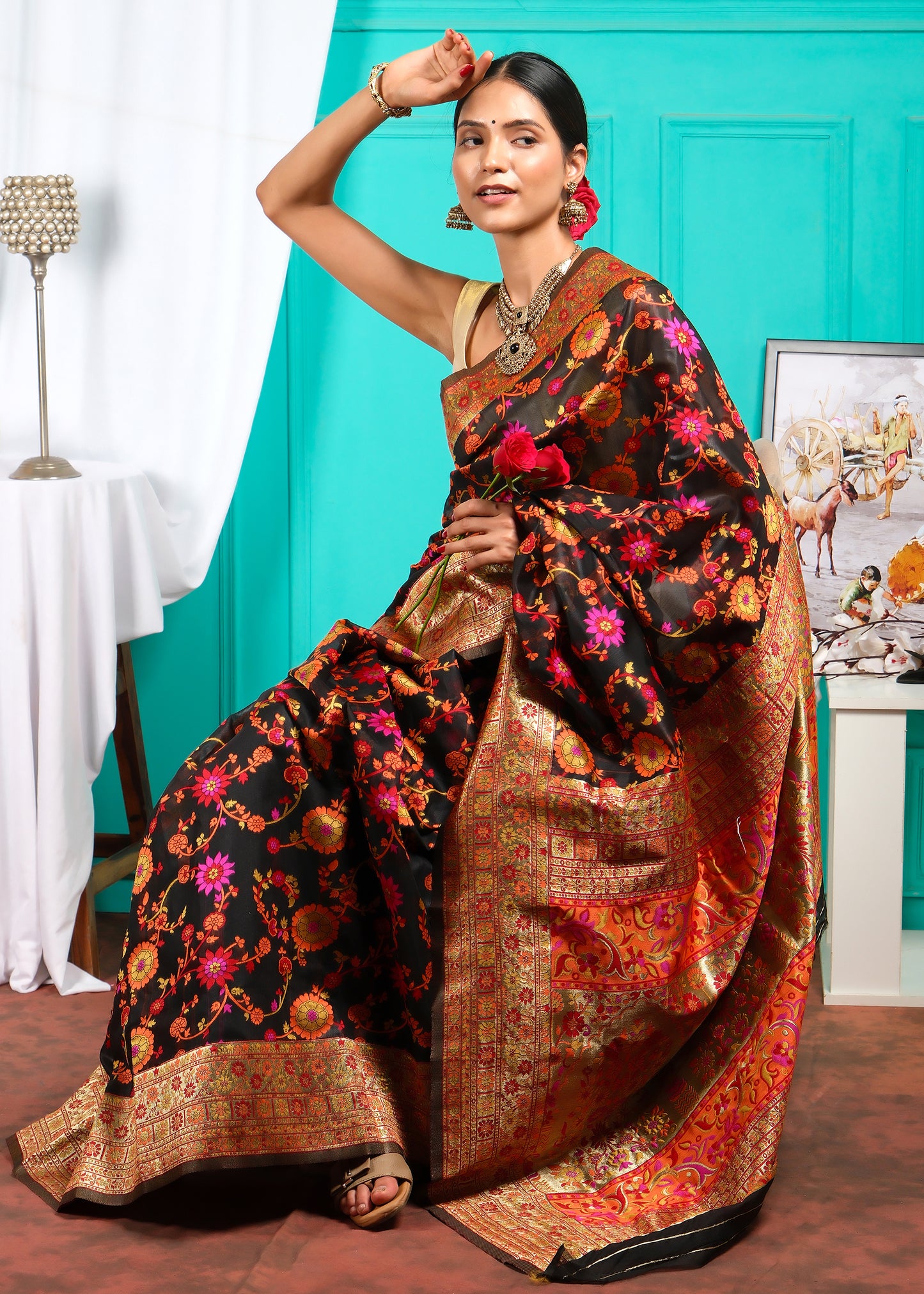 Elegant model in a traditional black Banarasi silk saree with floral embroidery, perfect for wedding and festive wear