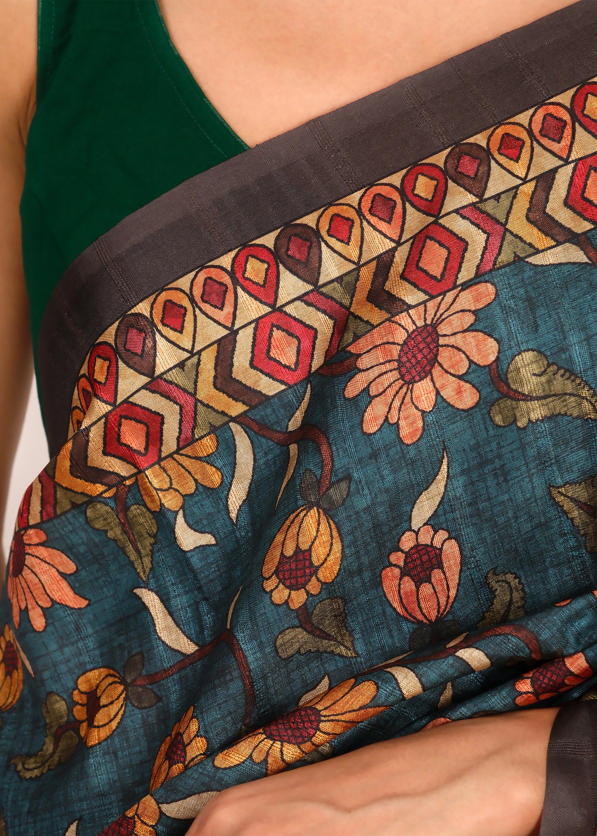 Close-up of saree showcasing intricate floral and geometric border patterns