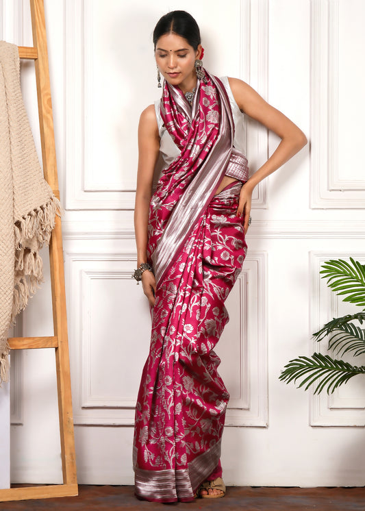 A full-length view of the model in a pink and silver Banarasi silk saree, radiating timeless elegance with the saree's floral designs and shimmering pallu