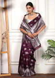 Elegant Draping of Purple and Silver Banarasi Silk Saree with Ornate Pallu
The model drapes the purple Banarasi silk saree with a silver pallu adorned with elephant motifs, paired with exquisite silver jewelry and floral accents.