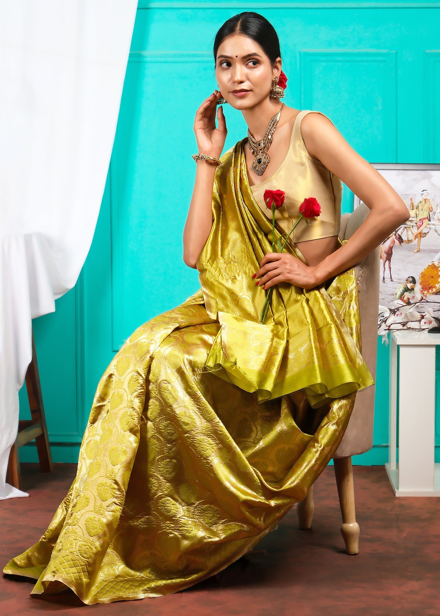 Classic yellow Banarasi silk saree with gold floral designs, worn by a model, symbolizing elegance