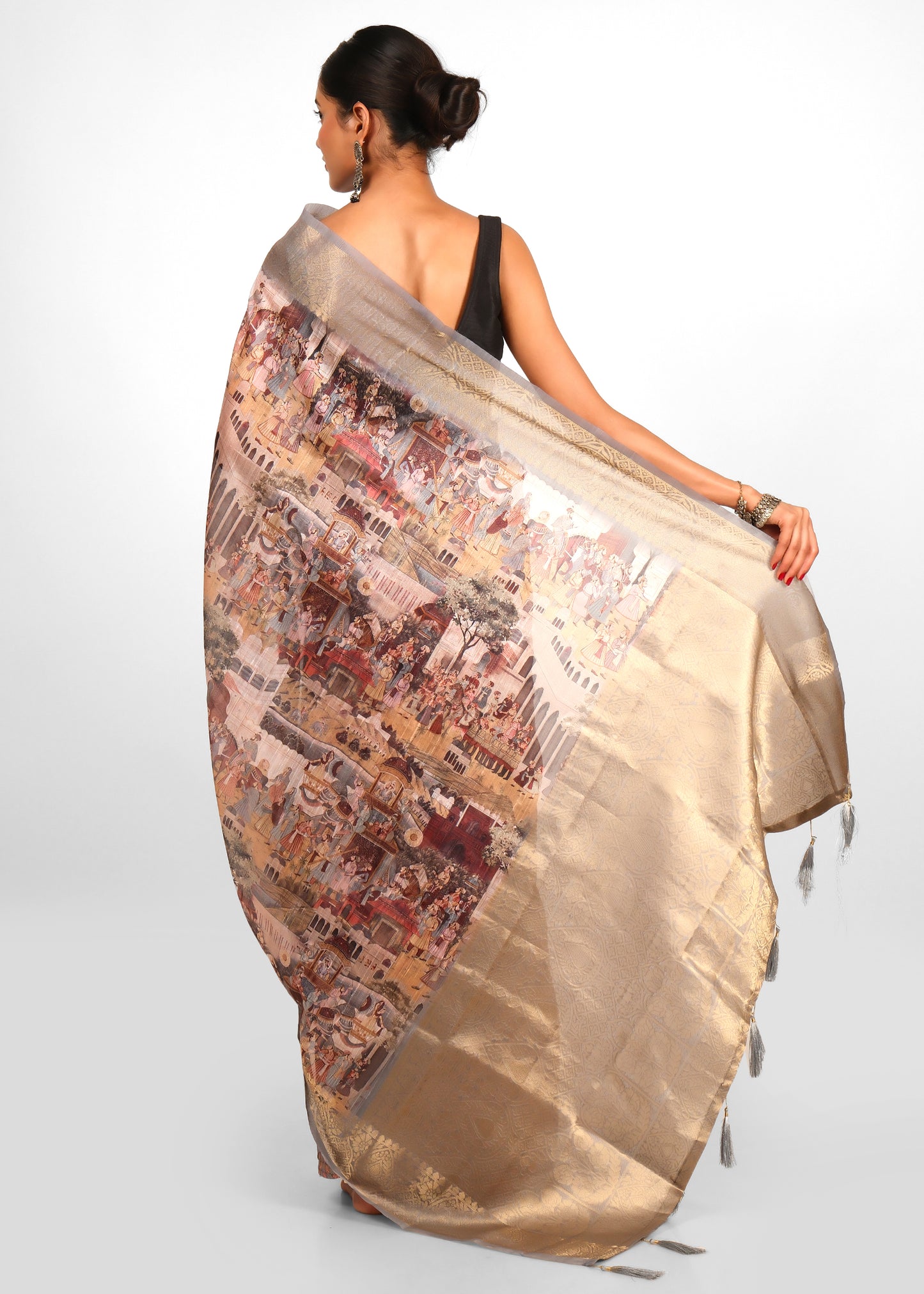 Woman displaying the exquisite artistry of a Mughal-inspired Banarasi silk saree from all angles.