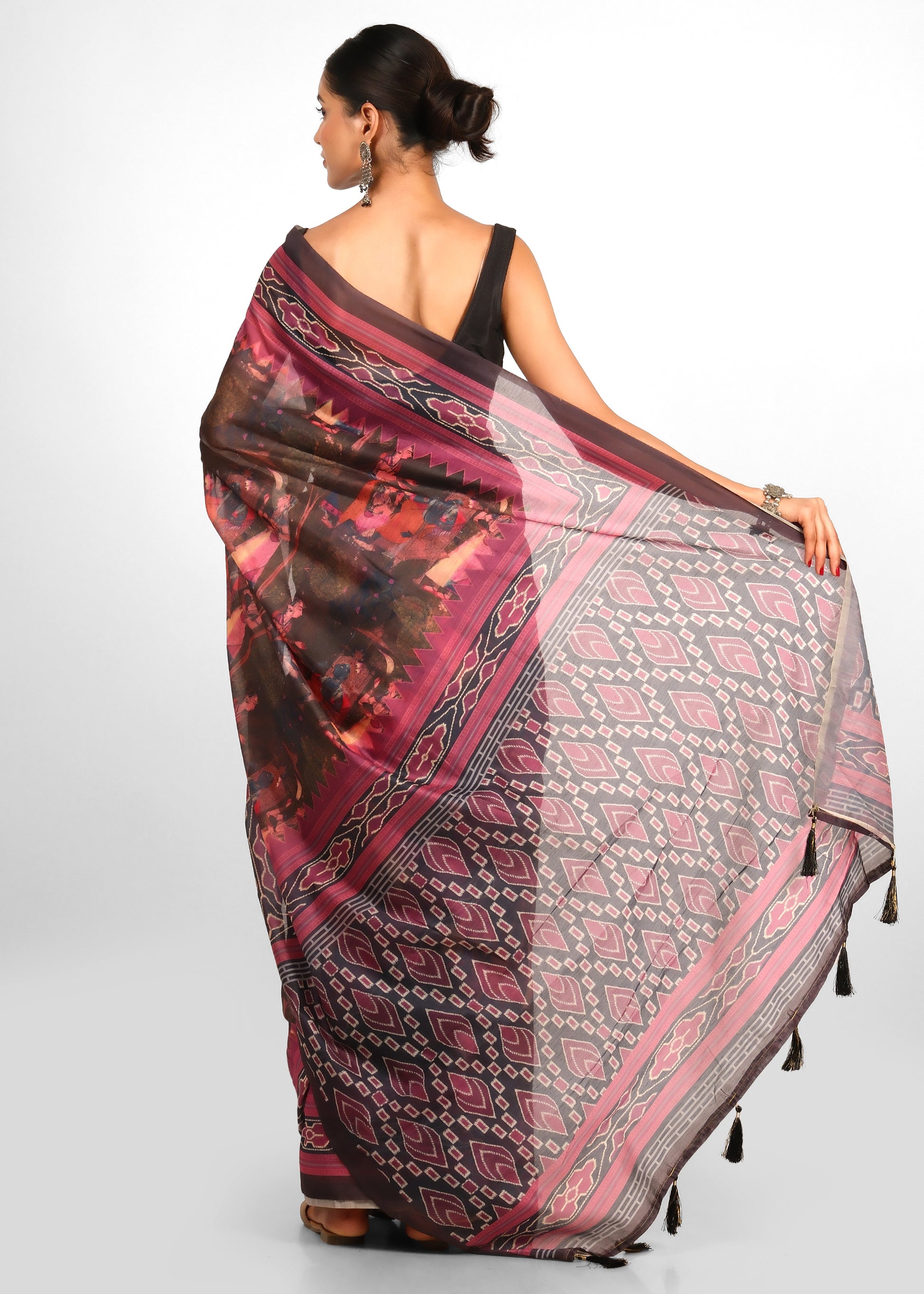 Rear view of a woman showcasing the intricate pallu design with Krishna Rasleela art in a handwoven saree.